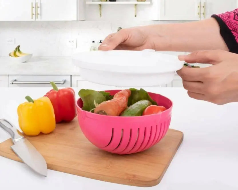 in a kitchen lady is covering the lid of the vegetable salad cutter