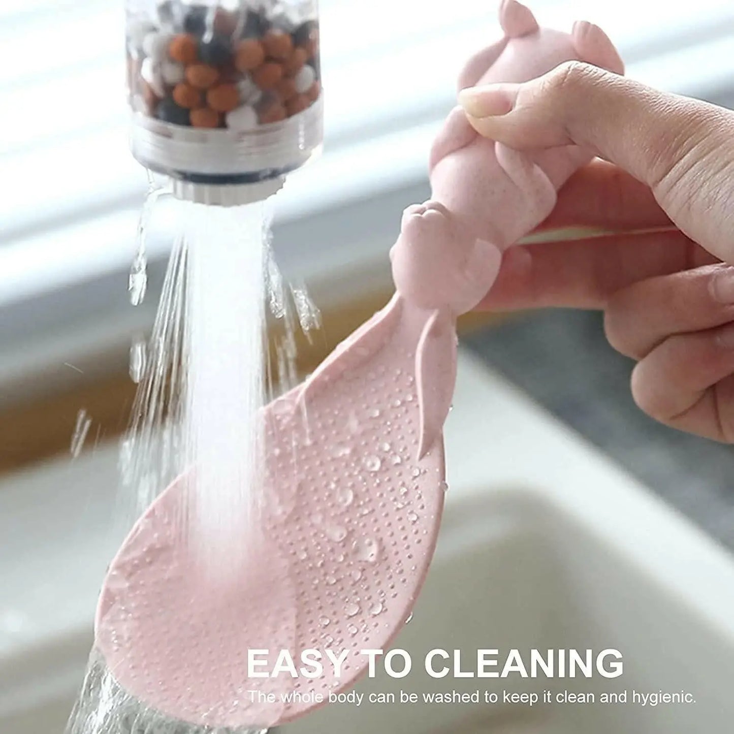 Spoon being washed in kitchen sink