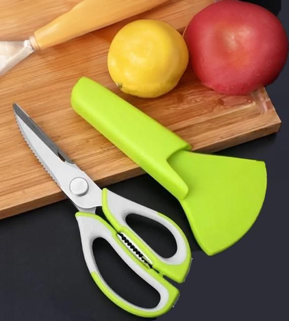 kitchen knife shown with tomato and on cutting board